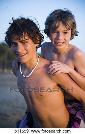 Two brothers playing on beach View Large Photo Image Stock Photo - Two brothers playing on beach. Fotosearch