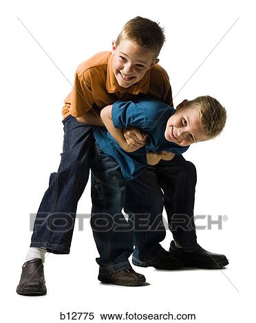 Stock Photography - Two brothers wrestling and play fighting. Fotosearch