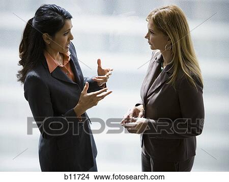 Two businesswomen talking View Large Photo Image Picture - Two businesswomen talking. Fotosearch