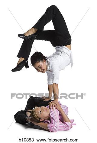 Two female contortionist businesswomen View Large Photo Image Stock Image - Two female contortionist businesswomen. Fotosearch
