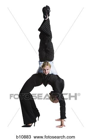 Two female contortionist businesswomen View Large Photo Image Stock Image - Two female contortionist businesswomen. Fotosearch