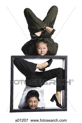 Two female contortionist businesswomen View Large Photo Image Stock Photo - Two female contortionist businesswomen. Fotosearch