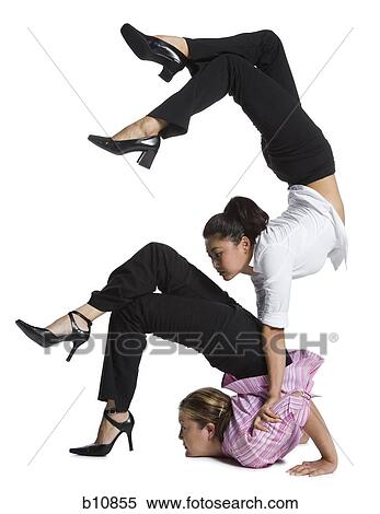 Two female contortionist businesswomen View Large Photo Image Stock Photography - Two female contortionist businesswomen. Fotosearch