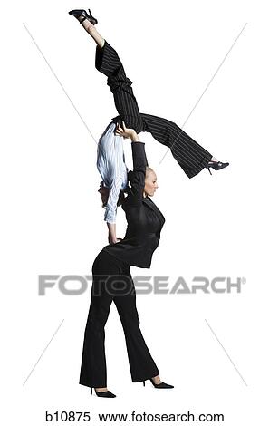 Two female contortionist businesswomen View Large Photo Image Stock Photography - Two female contortionist businesswomen. Fotosearch
