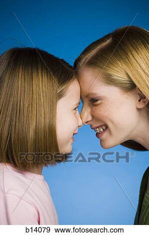 Two girls face to face smiling View Large Photo Image Stock Photo - Two girls face to face smiling. Fotosearch