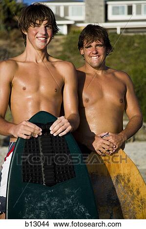 Two surfers on a beach View Large Photo Image Picture - Two surfers on a beach. Fotosearch
