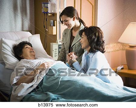 Two women talking with mature woman in hospital View Large Photo Image Stock Photography - Two women talking with mature woman in hospital. Fotosearch