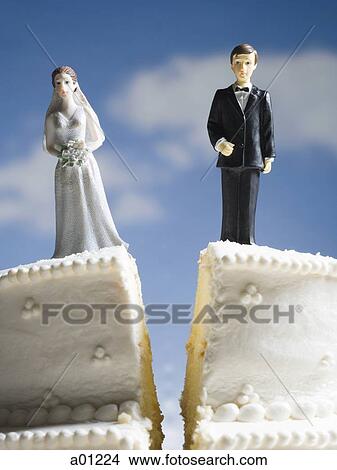 Picture - Wedding cake visual metaphor with figurine cake toppers. Fotosearch