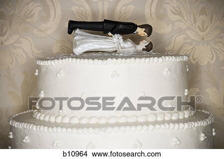 Picture - Wedding cake visual metaphor with figurine cake toppers. Fotosearch