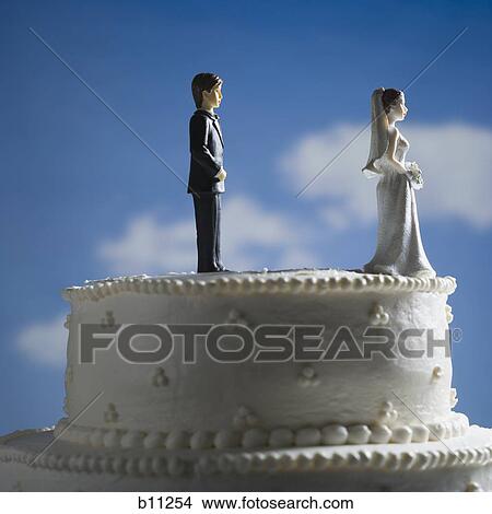 Wedding cake visual metaphor with figurine cake toppers View Large Photo Image Picture - Wedding cake visual metaphor with figurine cake toppers. Fotosearch