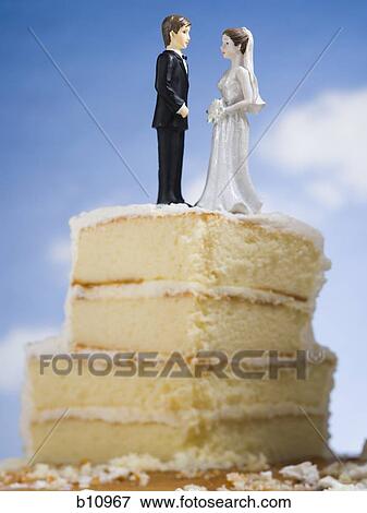 Wedding cake visual metaphor with figurine cake toppers View Large Photo Image Stock Photo - Wedding cake visual metaphor with figurine cake toppers. Fotosearch