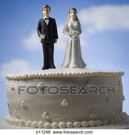 Wedding cake visual metaphor with figurine cake toppers View Large Photo Image Stock Photo - Wedding cake visual metaphor with figurine cake toppers. Fotosearch