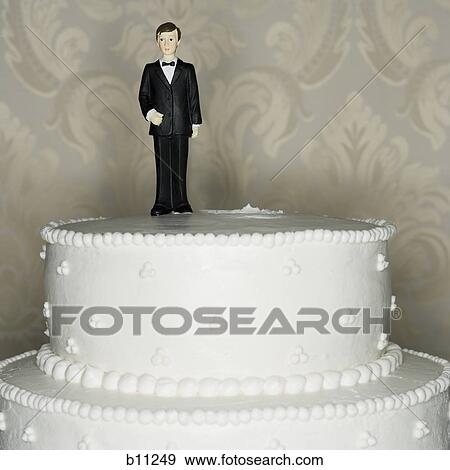 Wedding cake visual metaphor with figurine cake toppers View Large Photo Image Stock Photo - Wedding cake visual metaphor with figurine cake toppers. Fotosearch