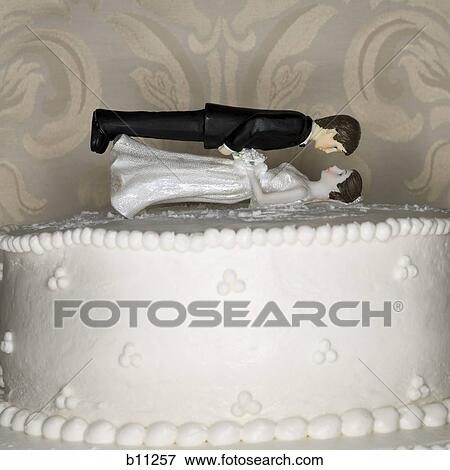 Wedding cake visual metaphor with figurine cake toppers View Large Photo Image Stock Photo - Wedding cake visual metaphor with figurine cake toppers. Fotosearch