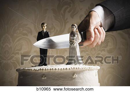 Stock Photography - Wedding cake visual metaphor with figurine cake toppers. Fotosearch
