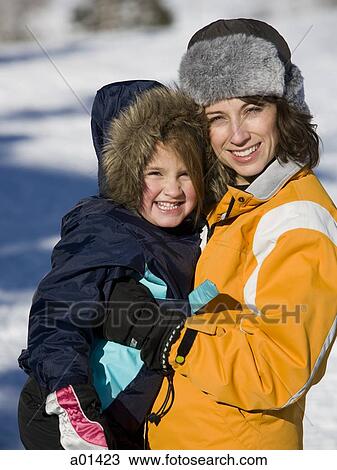 Woman and girl outdoors in winter smiling View Large Photo Image Stock Image - Woman and girl outdoors in winter smiling. Fotosearch