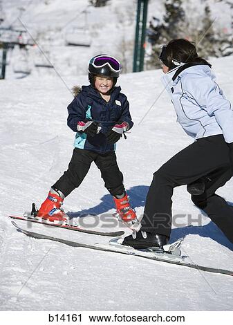Stock Image - Woman and young girl skiing. Fotosearch