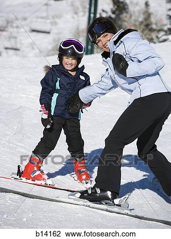 Woman and young girl skiing View Large Photo Image Stock Image - Woman and young girl skiing. Fotosearch