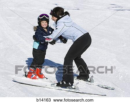 Woman and young girl skiing View Large Photo Image Stock Image - Woman and young girl skiing. Fotosearch