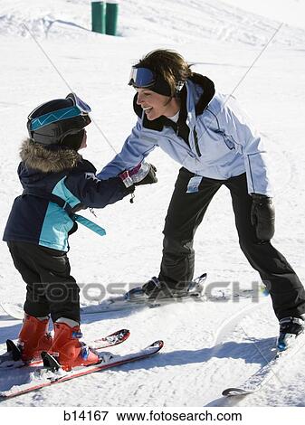 Stock Photo - Woman and young girl skiing. Fotosearch
