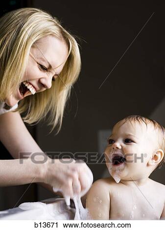 Woman bathing baby in sink View Large Photo Image Stock Image - Woman bathing baby in sink. Fotosearch