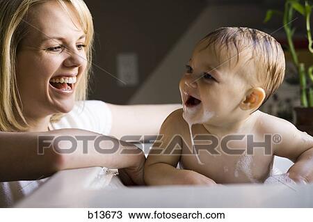 Woman bathing baby in sink View Large Photo Image Stock Image - Woman bathing baby in sink. Fotosearch