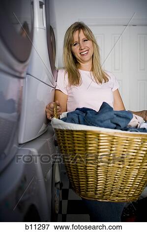 Woman doing laundry View Large Photo Image Stock Photo - Woman doing laundry. Fotosearch