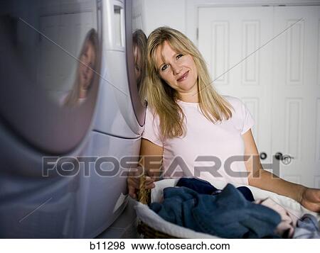 Woman doing laundry View Large Photo Image Stock Photo - Woman doing laundry. Fotosearch