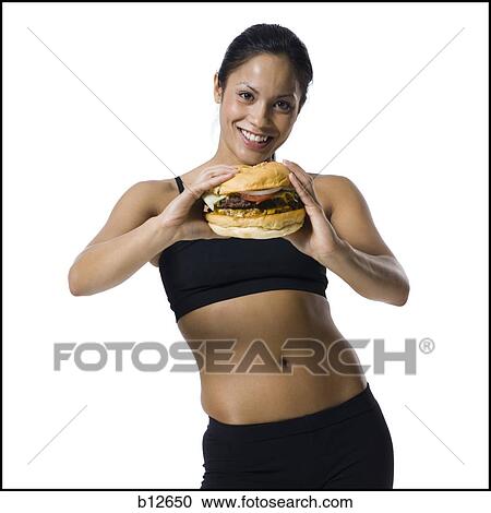 Woman eating a supersized hamburger View Large Photo Image Stock Image - Woman eating a supersized hamburger. Fotosearch