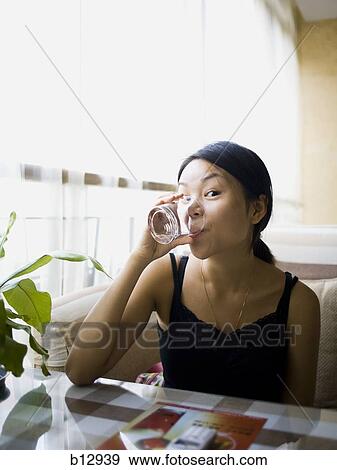 Woman eating at a Chinese food restaurant View Large Photo Image Stock Photo - Woman eating at a Chinese food restaurant. Fotosearch