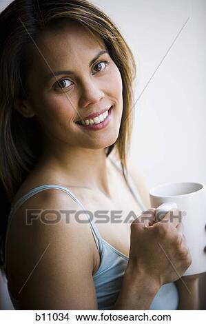 Picture - Woman enjoying a mug of coffee. Fotosearch