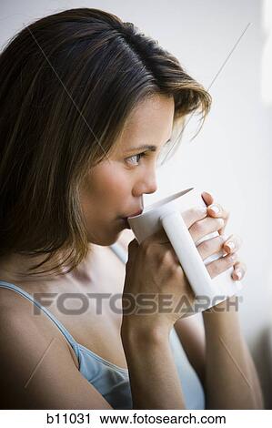Woman enjoying a mug of coffee View Large Photo Image Stock Image - Woman enjoying a mug of coffee. Fotosearch