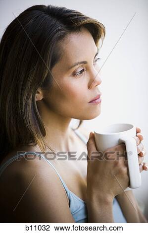 Woman enjoying a mug of coffee View Large Photo Image Stock Image - Woman enjoying a mug of coffee. Fotosearch