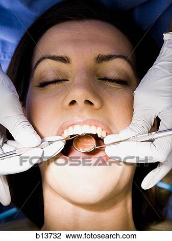 Stock Image - Woman having dental examination. Fotosearch