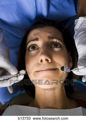 Stock Image - Woman having dental examination. Fotosearch