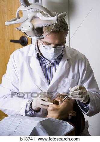 Stock Image - Woman having dental examination. Fotosearch
