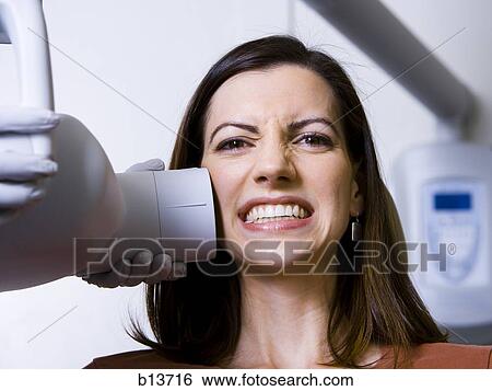 Stock Photograph - Woman having dental x-rays. Fotosearch