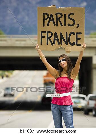 Woman hitchhiking a ride to Paris View Large Photo Image Stock Photo - Woman hitchhiking a ride to Paris. Fotosearch