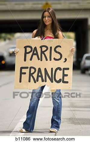 Woman hitchhiking a ride to Paris View Large Photo Image Stock Photograph - Woman hitchhiking a ride to Paris. Fotosearch