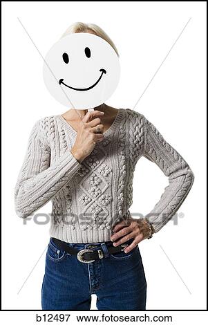 Woman holding a happy face mask View Large Photo Image Stock Photo - Woman holding a happy face mask. Fotosearch