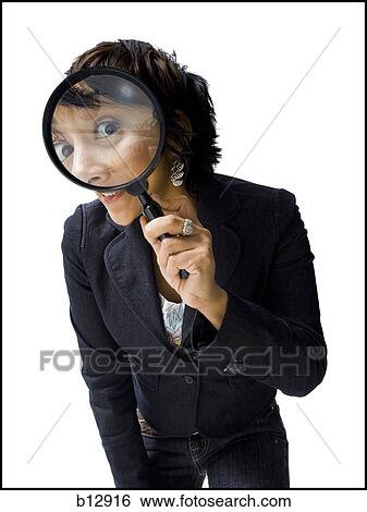 Stock Photograph - Woman holding and looking through magnifying glass. Fotosearch