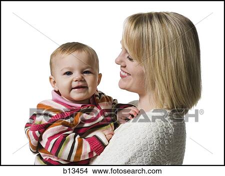 Woman holding baby girl View Large Photo Image Picture - Woman holding baby girl. Fotosearch