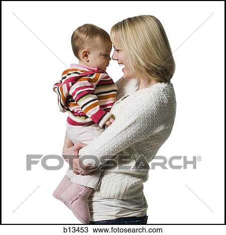 Woman holding baby girl View Large Photo Image Stock Image - Woman holding baby girl. Fotosearch