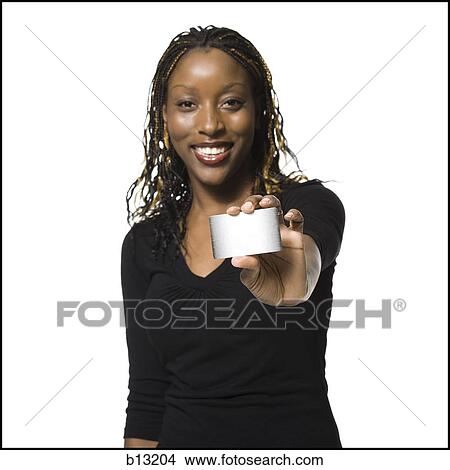 Picture - Woman holding bank card smiling. Fotosearch