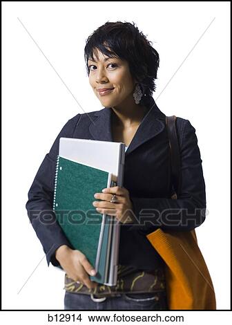 Woman holding books and laptop View Large Photo Image Picture - Woman holding books and laptop. Fotosearch