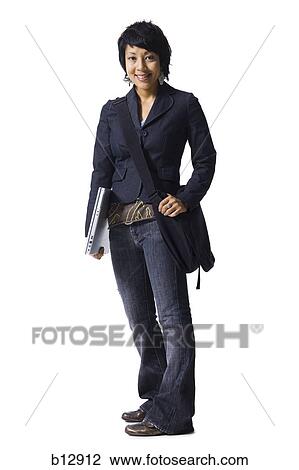 Stock Image - Woman holding books and laptop. Fotosearch