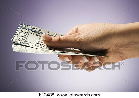 Stock Photography - Woman holding concert tickets. Fotosearch