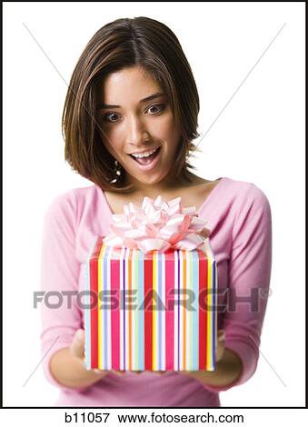 Stock Photo - Woman holding gift box. Fotosearch