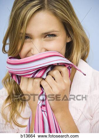 Picture - Woman holding shirt up smiling. Fotosearch