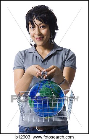 Woman holding shopping basket with globe View Large Photo Image Stock Image - Woman holding shopping basket with globe. Fotosearch